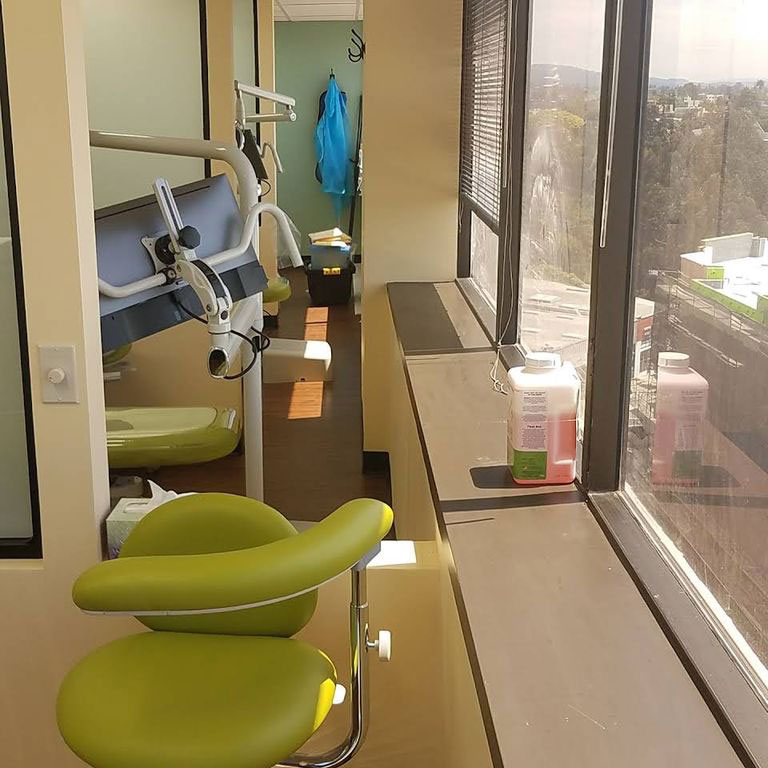 An interior view of a dental office waiting area with modern equipment and furnishings.