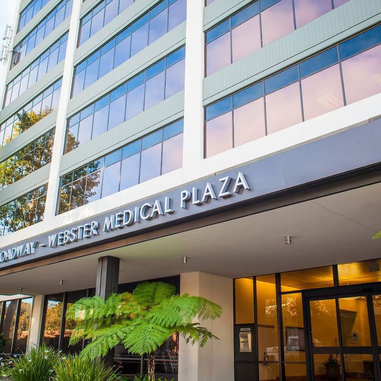 The image shows a modern building with a sign that reads  WESTERN MEDICAL PLAZA,  indicating that this building houses medical facilities.