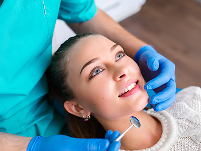 The image shows a dental professional performing a procedure on a patient s teeth with a focus on oral hygiene and dental care.